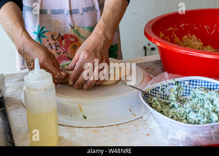 Preparing stuffed pita with labaneh and hyssop Stock Photo
