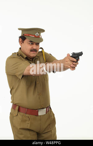 Policeman pointing gun Stock Photo