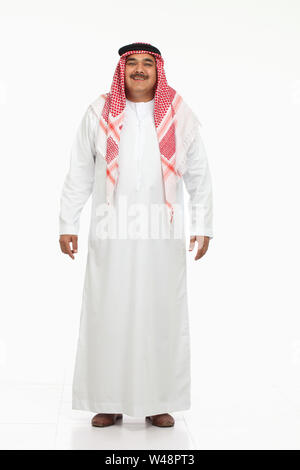 Arabian man standing and smiling Stock Photo