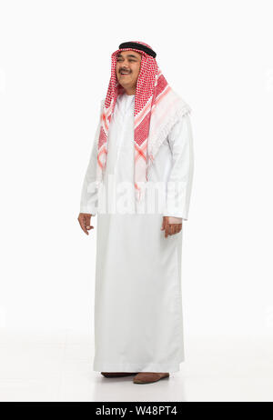 Arabian man standing and smiling Stock Photo