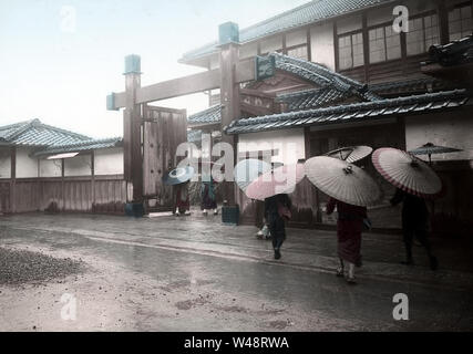 [ 1900s Japan - Japanese Elementary School Students ] —   Elementary school students with paper umbrellas arrive at the school gate.  This image is part of 'The School Life of Young Japan' (No 1), a series published by Japanese photographer Kozaburo Tamamura in the early 1900s (late Meiji).  20th century vintage glass slide Stock Photo