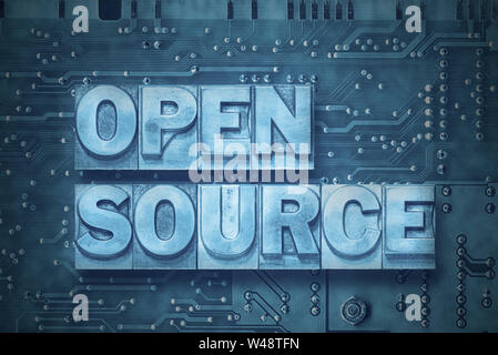 open source phrase made from metallic letterpress blocks on the pc board background Stock Photo