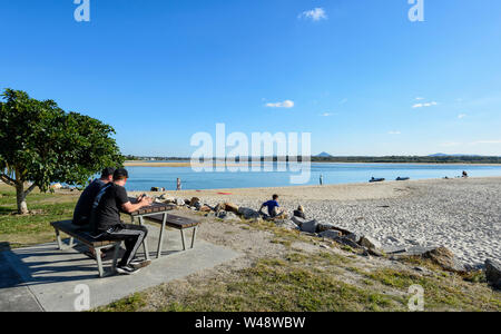 Relaxed beach scene at Noosa Main Beach on a sunny day, Noosa Heads, Sunshine Coast, Queensland, QLD, Australia Stock Photo