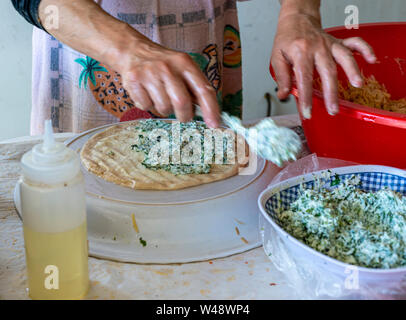 Preparing stuffed pita with labaneh and hyssop Stock Photo