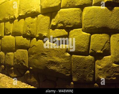 View to Twelve-angled stone aka Hatun Rumiyoc as a part of a wall of the palace of the Archbishop of Cuzco in Peru Stock Photo