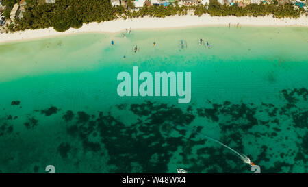 Tropical white sand beach in a lagoon with turquoise water on Boracay Island, Philippines., aerial view. Seascape with beach on tropical island. Summer and travel vacation concept. Stock Photo