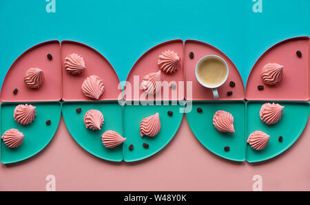 Geometric paper background in mint and coral colors with coffee and marshmallows Stock Photo
