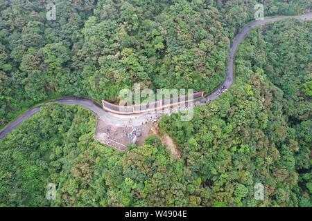 (190721) -- BEIJING, July 21, 2019 (Xinhua) -- Aerial photo taken on June 30, 2019 shows tourists taking a tour on the Laoshanjie Mountain in Xing'an County of south China's Guangxi Zhuang Autonomous Region. (Xinhua/Lu Boan) Stock Photo