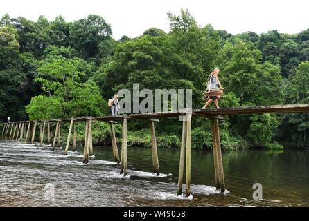 (190721) -- BEIJING, July 21, 2019 (Xinhua) -- Villagers walk on a Red Army Bridge in Liping County, southwest China's Guizhou Province, July 2, 2019. (Xinhua/Yang Wenbin) Stock Photo