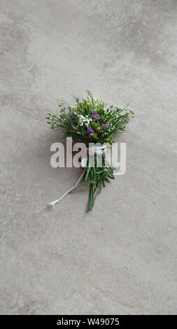 Festive wild flowers composition on the grey background. Overhead view Stock Photo