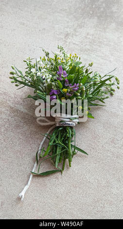 Festive wild flowers composition on the grey background. Overhead view Stock Photo