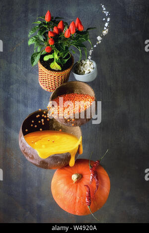 Pumpkin and lentil soup and its ingredients, creative food background Stock Photo