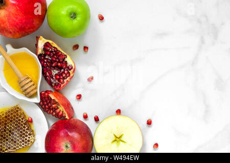 Honey, apple and pomegranate. traditional food for Jewish New Year Holiday, Rosh Hashanah. top view with copy space Stock Photo