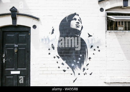 Ilhan Omar mural or graffiti art on a wall, Birmingham, Small Heath, UK Stock Photo