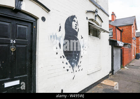 Ilhan Omar mural or graffiti art on a wall, Birmingham, Small Heath, UK Stock Photo