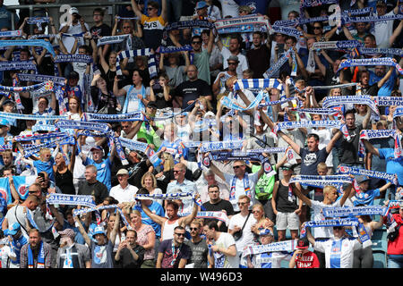 Rostock, Germany. 20th July, 2019. Soccer: 3rd league, 1st matchday, FC Hansa Rostock - Viktoria Köln in the Ostseestadion: Before the match starts, Hansa fans hold up their scarves and sing. Credit: Bernd Wüstneck/dpa-Zentralbild/dpa/Alamy Live News Stock Photo