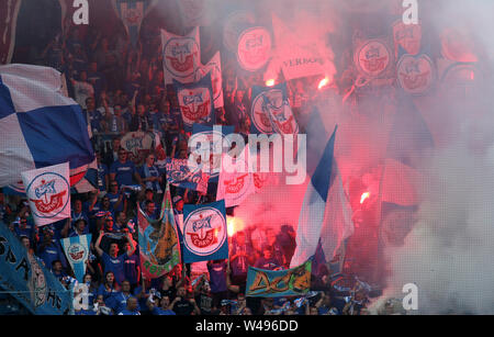 Rostock, Germany. 20th July, 2019. Soccer: 3rd league, 1st matchday, FC Hansa Rostock - Viktoria Köln in the Ostseestadion: At the start of the match, Hansa fans wave blue and white Hansa flags on the south stand and burn down pyrotechnics. Credit: Bernd Wüstneck/dpa-Zentralbild/dpa/Alamy Live News Stock Photo