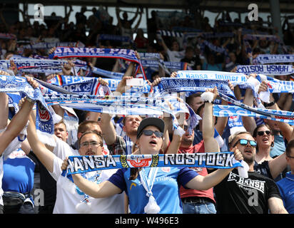 Rostock, Germany. 20th July, 2019. Soccer: 3rd league, 1st matchday, FC Hansa Rostock - Viktoria Köln in the Ostseestadion: Before the match starts, Hansa fans hold up their scarves and sing. Credit: Bernd Wüstneck/dpa-Zentralbild/dpa/Alamy Live News Stock Photo