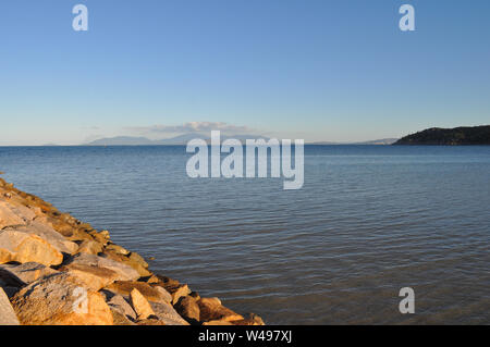 View from  Nelly Bay on Magnetic Island towards the mainland at Townsville, Queensland, Australia on a calm, winter day. Stock Photo