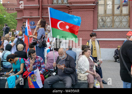 MOSCOW, RUSSIA - MAY 9, 2019: Immortal regiment procession in Victory Day. A man holding Azerbaijan flag Stock Photo