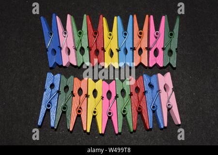 Top view of multicolored photo clips arranged in two rows. Stock Photo