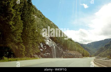 Norway landscape with mountains and waterfalls Seven Sisters at summertime. Norway nature and travel background. Camera hovers above the water, view Stock Photo