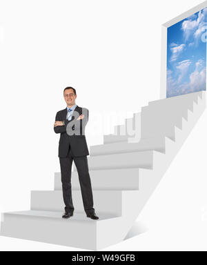 Businessman standing with his arms crossed and smiling Stock Photo