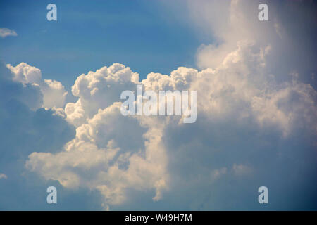 clouds background with blue sky, big cumulus clouds in front of blue azure sky just before a storm Stock Photo