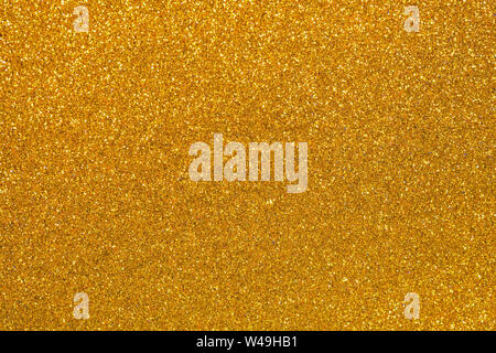 Gold glitter texture sparkling shiny wrapping paper background for Christmas holiday seasonal wallpaper decoration, greeting and wedding invitation ca Stock Photo