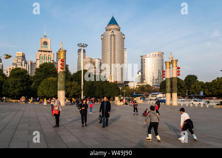 Guiyang, China - February 9 2019: People enjoy a sunny winter day in Guiyang downtown district, Renmin square, in Guizhou province in China. Stock Photo