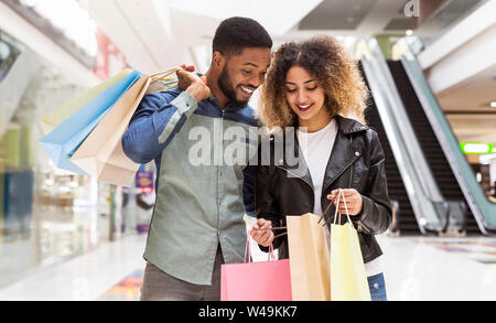 Happy african american couple discussing purchases and smiling Stock Photo