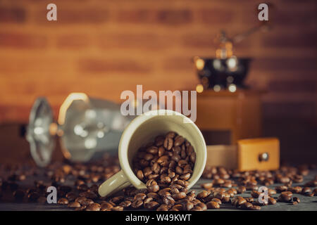 Coffee bean in the white cup and coffee grinder on wooden table. Concept breakfast or coffee time in morning. Stock Photo