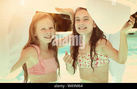 Friends in the pool on a hot day Stock Photo