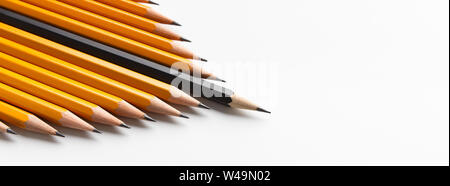 Group of yellow classic pencils following black one Stock Photo