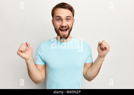energetic young positive business man enjoying success, rejoicing at good day, victory. close up portrait. isolated white backgrond. happiness. luck Stock Photo