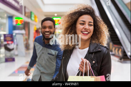 Happy African american couple fooling in shopping center Stock Photo