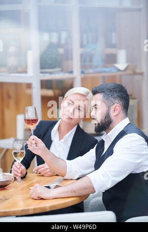 Professional cavists with wine samples examining their color Stock Photo