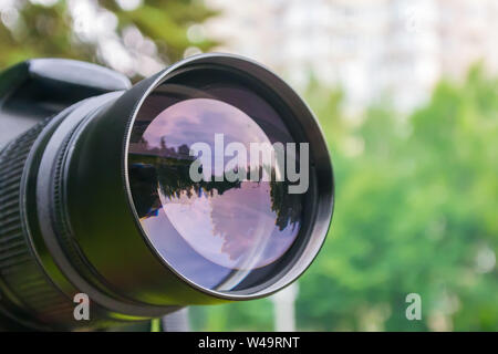 Close-up of the camera lens in which the street is reflected Stock Photo