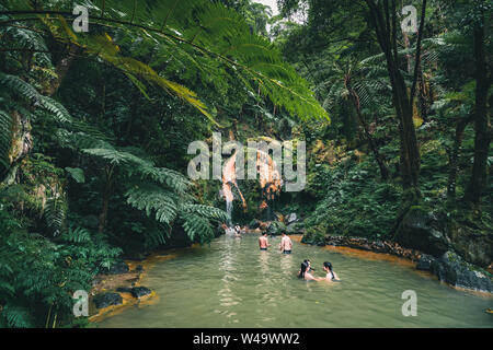 SAO MIGUEL, AZORES, PORTUGAL - JULY 29, 20189 People enjoy bath in natural thermal pools, spa of Caldeira Velha near Ribeira Grande town, Sao Miguel Stock Photo