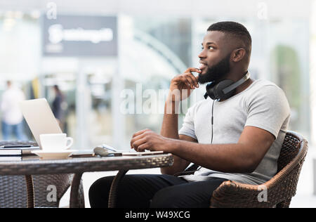Handsome african american guy looking away and thinking Stock Photo
