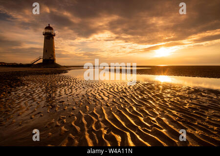 Sunset at the Point of Ayr Lighthouse at Talacre Beach, Prestatyn North Wales UK Stock Photo