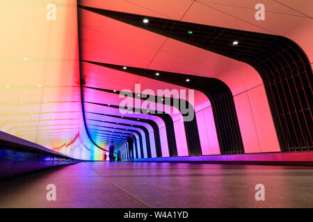 The King's Cross Tunnel, a pedestrian light tunnel with LED ‘art wall’ currently illuminated in pride rainbow colours Stock Photo
