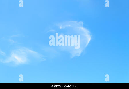 Light white translucent cirrus cloud high in the blue summer sky. Different cloud types and atmospheric phenomena. Skyscape on a sunny day. Stock Photo
