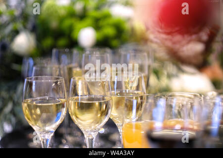 Glasses of wine and juice on a serving table at a buffet table Stock Photo