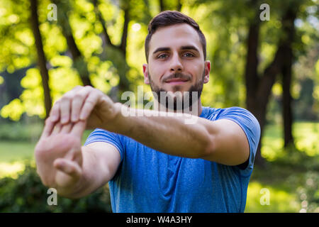 Handsome man exercising in the park. Stock Photo