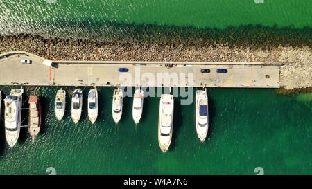 Aerial overhead shot of various types of boats docked near the coast at the sea Stock Photo