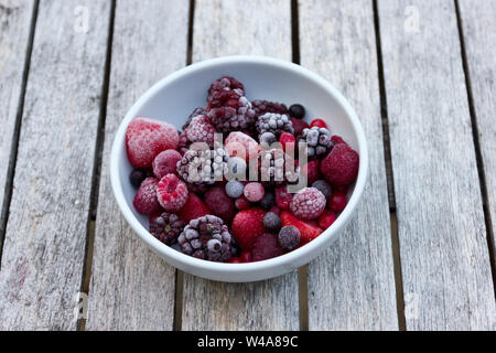 Frozen berries in a white bowl Stock Photo