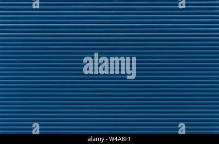 Background texture of dark blue indigo color painted horizontal metal window roller shutter blinds Stock Photo