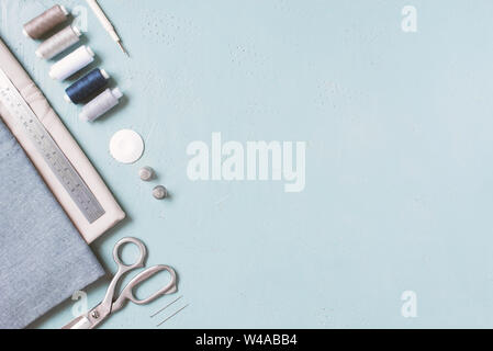 Blue textured background with sewing tools, copy space Stock Photo