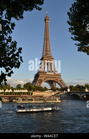 Paris/France - August 18, 2014: Beautiful panoramic view to the Eiffel Tower and river Seine intense cruise passenger ships traffic in a sunny day. Stock Photo